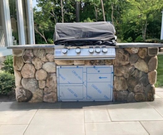 Stone outdoor kitchen from a house in chatham, MA. Designed by Cape Cod Hardscapes