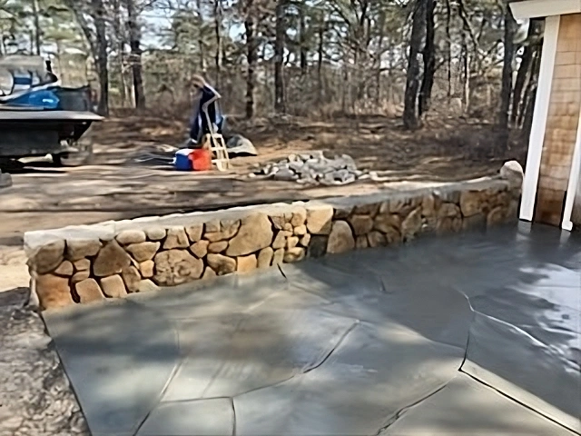 Stone pavers in a driveway from a house in Truro, MA. Designed by Cape Cod Hardscapes